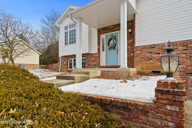 view of snow covered property entrance