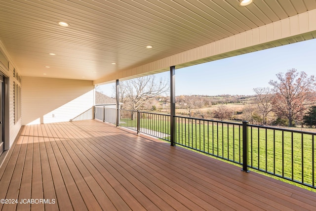 wooden deck with a lawn