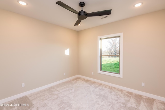 carpeted spare room featuring ceiling fan