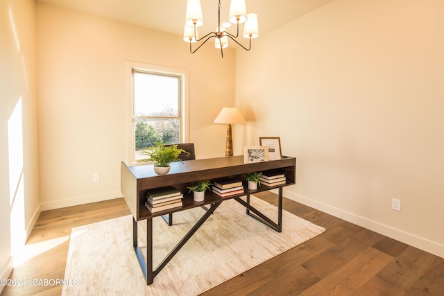 office featuring wood-type flooring and an inviting chandelier