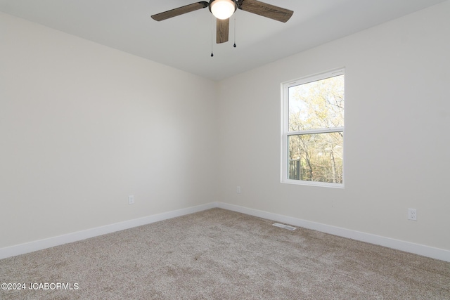 empty room with light colored carpet and ceiling fan