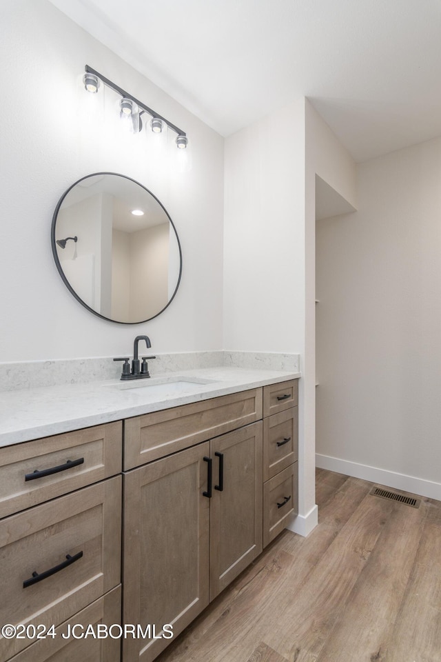 bathroom featuring vanity and wood-type flooring