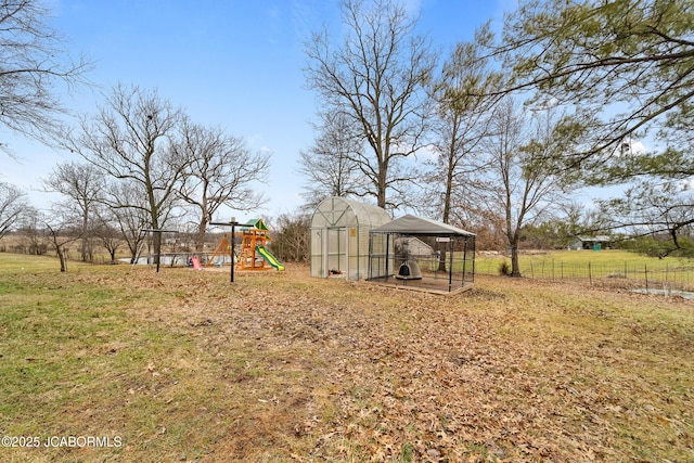 view of yard with a playground and an outbuilding