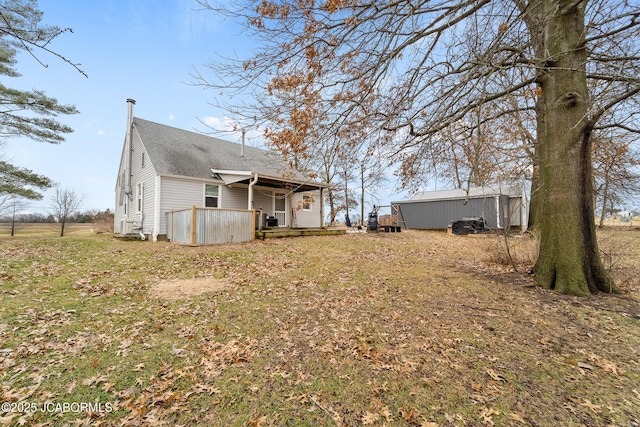 rear view of property featuring a yard