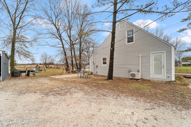 view of side of home featuring ac unit