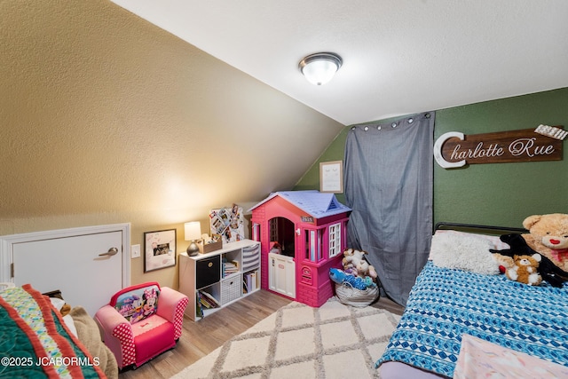 bedroom featuring vaulted ceiling and hardwood / wood-style floors