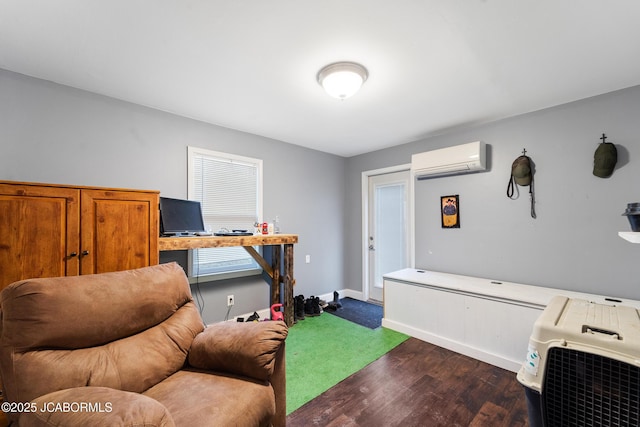 home office with dark wood-type flooring and a wall mounted air conditioner