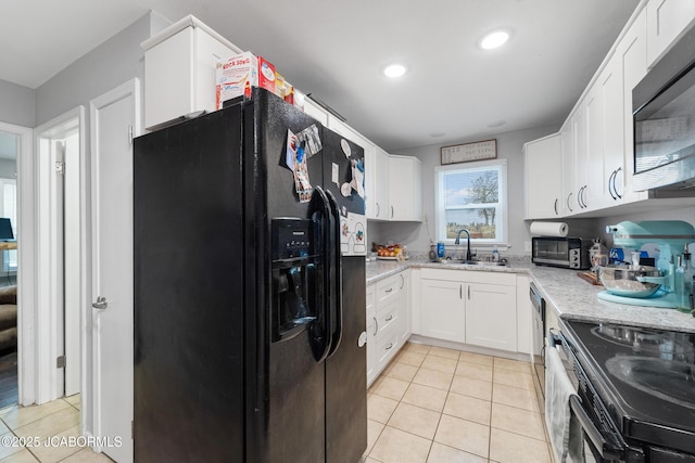 kitchen with black fridge with ice dispenser, sink, stainless steel range with electric cooktop, light tile patterned floors, and white cabinets