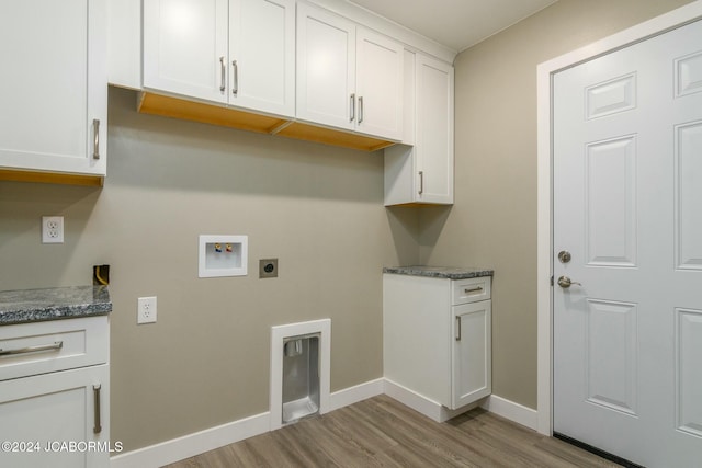 washroom with electric dryer hookup, light hardwood / wood-style flooring, cabinets, and washer hookup