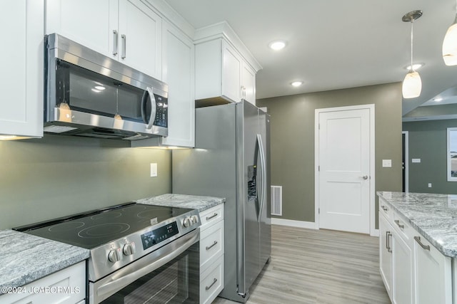 kitchen featuring white cabinets, decorative light fixtures, stainless steel appliances, and light stone countertops