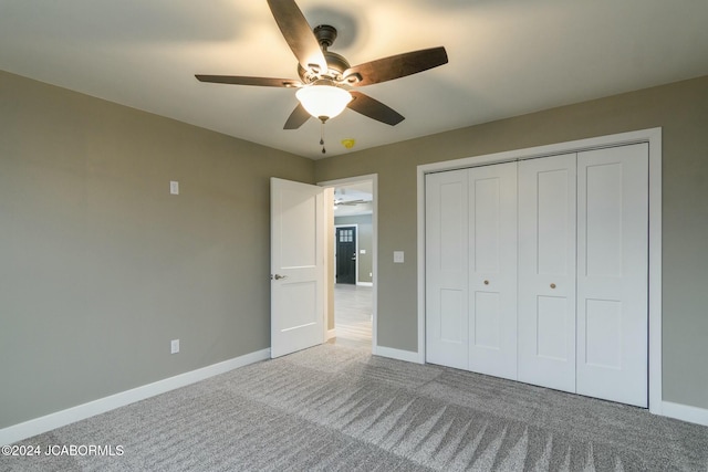 unfurnished bedroom featuring carpet flooring, ceiling fan, and a closet