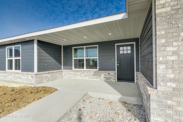 view of exterior entry with a porch