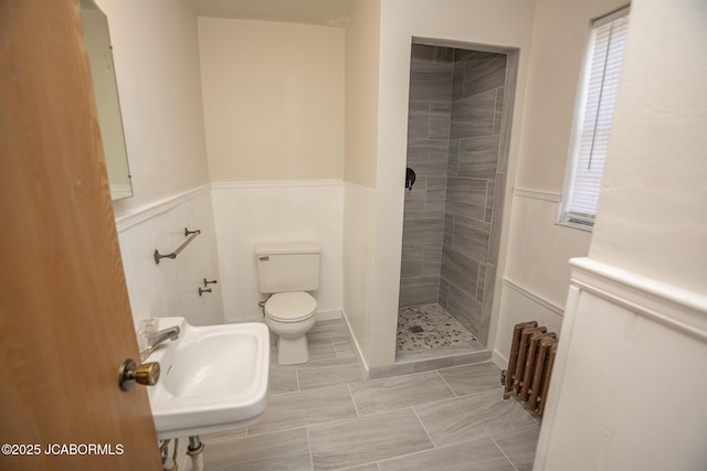210 E Dunklin St, Jefferson City, MO 65101 - full bath featuring a sink, radiator heating unit, toilet, a stall shower, and wainscoting