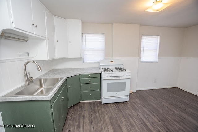 210 E Dunklin St, Jefferson City, MO 65101 - kitchen featuring white gas range oven, green cabinets, a sink, dark wood-style flooring, and white cabinets