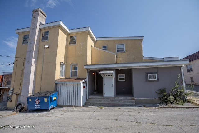 210 E Dunklin St, Jefferson City, MO 65101 - view of front of home with stucco siding and a chimney