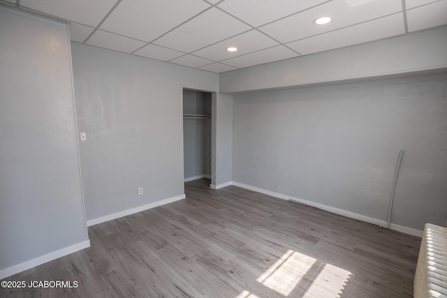 210 E Dunklin St, Jefferson City, MO 65101 - unfurnished bedroom featuring a paneled ceiling, wood finished floors, baseboards, radiator heating unit, and recessed lighting