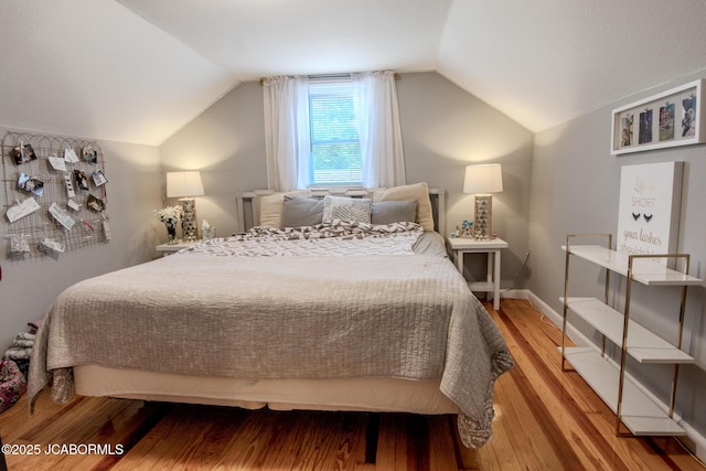 713 S Summit Dr, Holts Summit, MO 65043 - bedroom with lofted ceiling and wood finished floors