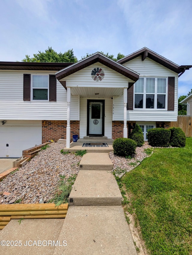 5416 S Brooks Dr, Jefferson City, MO 65109 - bi-level home with an attached garage, brick siding, and covered porch