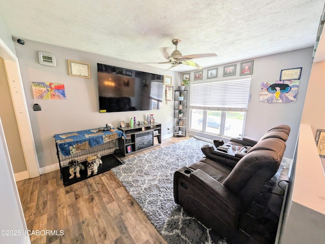 5416 S Brooks Dr, Jefferson City, MO 65109 - living room featuring a ceiling fan, wood finished floors, and a textured ceiling