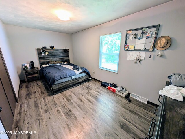 5416 S Brooks Dr, Jefferson City, MO 65109 - bedroom featuring wood finished floors and baseboards
