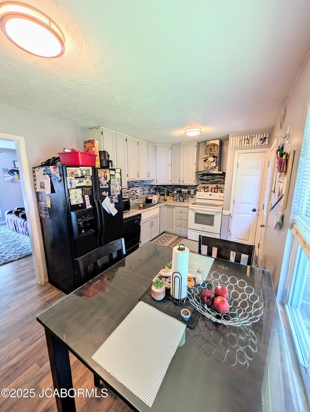 5416 S Brooks Dr, Jefferson City, MO 65109 - kitchen with black fridge with ice dispenser, white electric range oven, tasteful backsplash, wood finished floors, and light countertops