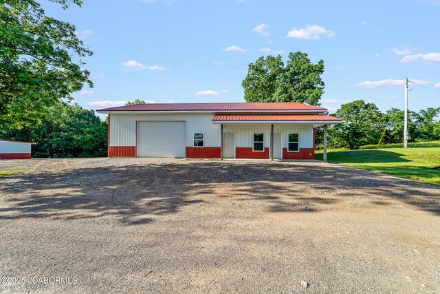 4604 County Rd 115, Fulton, MO 65251 - view of front of property featuring an outdoor structure, a garage, driveway, and metal roof