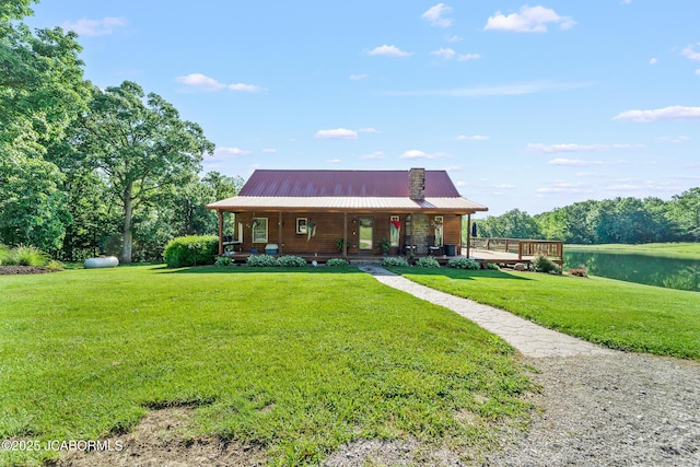 4604 County Rd 115, Fulton, MO 65251 - view of front of home featuring a front lawn, covered porch, a water view, and metal roof