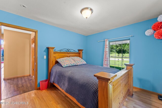 4604 County Rd 115, Fulton, MO 65251 - bedroom featuring wood finished floors and baseboards