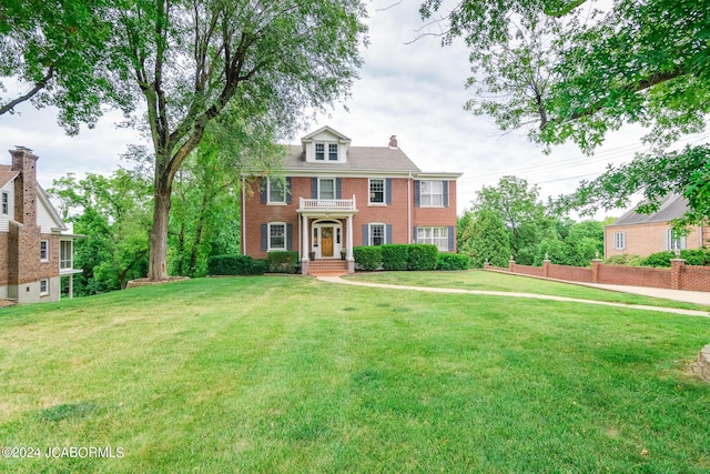 colonial-style house with a front lawn