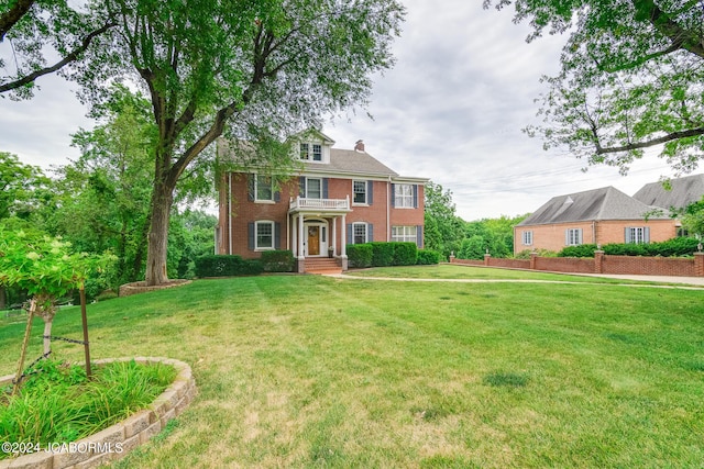 colonial-style house with a front yard