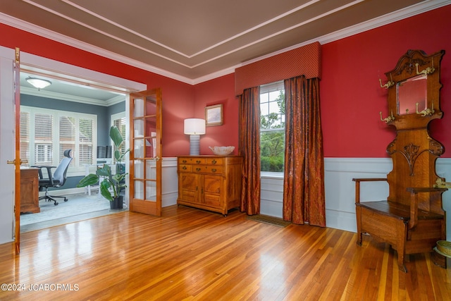 living area with french doors, crown molding, and hardwood / wood-style flooring