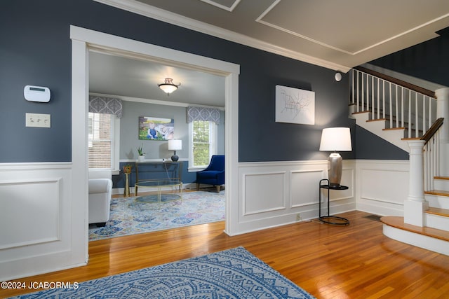 interior space featuring ornamental molding and hardwood / wood-style flooring