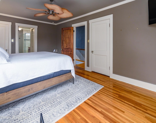 bedroom with ceiling fan, ornamental molding, hardwood / wood-style floors, and ensuite bath