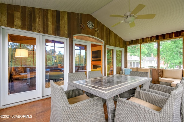 sunroom with lofted ceiling and ceiling fan