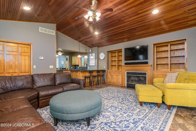 living room with high vaulted ceiling, ceiling fan, and built in features