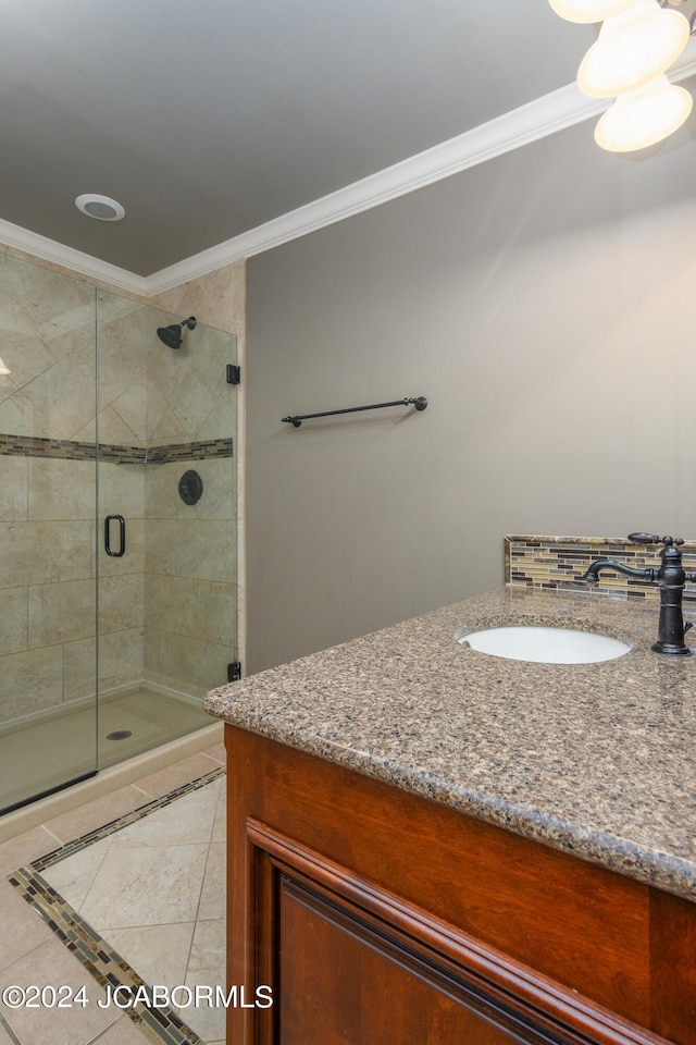 bathroom featuring sink, crown molding, tile patterned flooring, and an enclosed shower