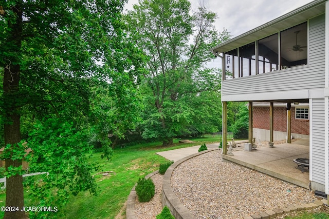 view of yard with a sunroom and a patio