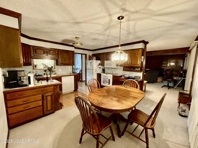 700 S Bowling St, California, MO 65018 - dining space featuring a chandelier, a textured ceiling, and crown molding