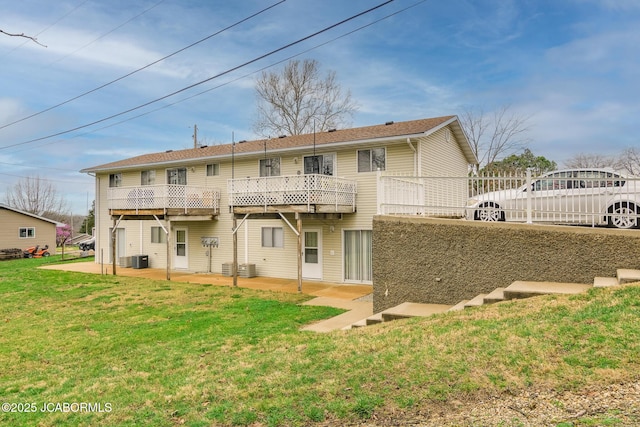 back of house with a lawn, central AC unit, fence, and a patio area