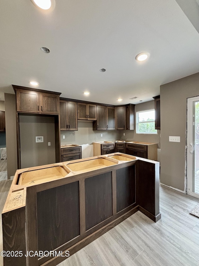 209 Gavin Ln, Linn, MO 65051 - kitchen featuring dark brown cabinetry, light wood-style floors, a center island, and recessed lighting