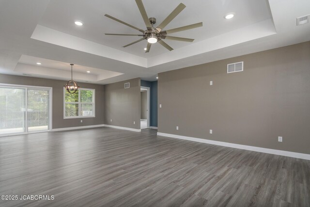 209 Gavin Ln, Linn, MO 65051 - spare room with a tray ceiling, ceiling fan, wood finished floors, a chandelier, and recessed lighting