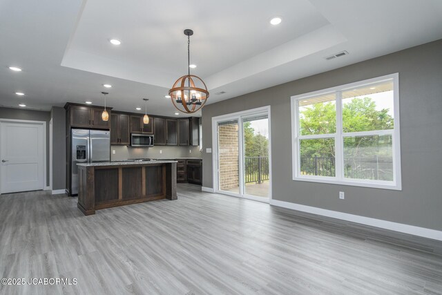 209 Gavin Ln, Linn, MO 65051 - kitchen featuring appliances with stainless steel finishes, a tray ceiling, recessed lighting, dark brown cabinets, and a chandelier