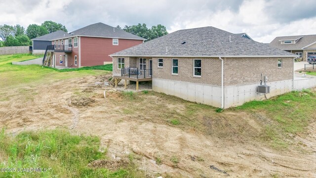 209 Gavin Ln, Linn, MO 65051 - rear view of house featuring a deck, brick siding, and roof with shingles