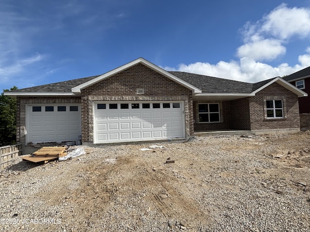 209 Gavin Ln, Linn, MO 65051 - single story home featuring a garage, brick siding, driveway, and roof with shingles