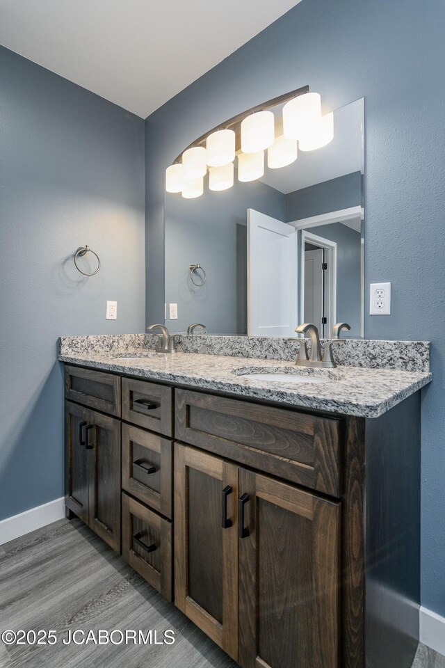 209 Gavin Ln, Linn, MO 65051 - bathroom featuring double vanity and wood finished floors