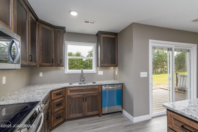 209 Gavin Ln, Linn, MO 65051 - kitchen featuring stainless steel appliances, light wood-type flooring, light stone countertops, plenty of natural light, and recessed lighting