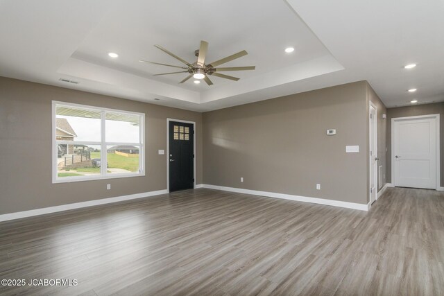 209 Gavin Ln, Linn, MO 65051 - unfurnished room with a raised ceiling, a ceiling fan, light wood-style flooring, and recessed lighting
