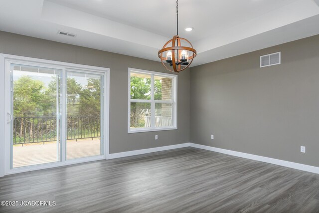 209 Gavin Ln, Linn, MO 65051 - unfurnished room with a chandelier, dark wood finished floors, recessed lighting, and a tray ceiling