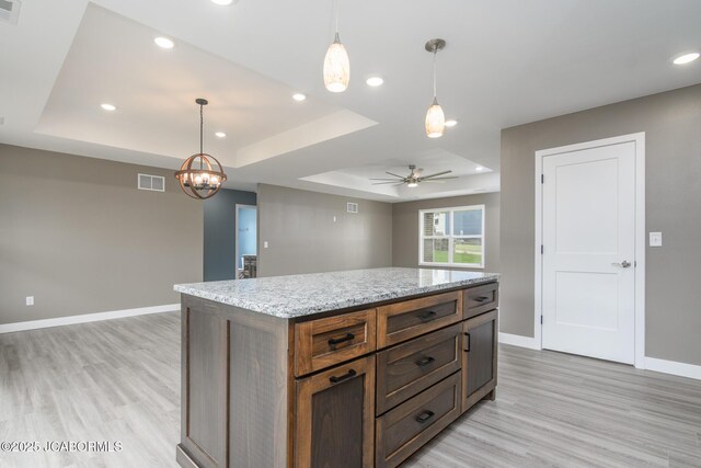 209 Gavin Ln, Linn, MO 65051 - kitchen with a tray ceiling, light wood finished floors, a ceiling fan, recessed lighting, and pendant lighting