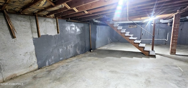 unfinished basement featuring stairs